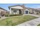 Single-story home showcasing a manicured lawn, rock landscaping and a two-car garage at 3504 E Boot Track Trl, Gilbert, AZ 85296