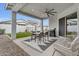 Stylish covered patio featuring a dining set, outdoor lounge chairs, and a modern ceiling fan for ultimate comfort at 3504 E Boot Track Trl, Gilbert, AZ 85296