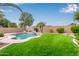 Expansive backyard with a sparkling pool, lush lawn, and mature trees at 3790 S Velero St, Chandler, AZ 85286