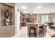 Kitchen with stainless steel appliances, granite countertops, kitchen island with barstool seating and adjacent dining area at 3790 S Velero St, Chandler, AZ 85286