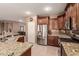 Modern kitchen featuring stainless steel appliances, granite countertops, and tile flooring at 3790 S Velero St, Chandler, AZ 85286