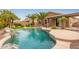 Inviting backyard pool with rock waterfall feature and lush landscaping at 3790 S Velero St, Chandler, AZ 85286