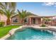 Backyard pool with a beach entry, beautiful landscaping, and an outdoor patio perfect for entertaining at 3790 S Velero St, Chandler, AZ 85286