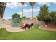 Spacious backyard with a pool, bar area, lounge seating, grassy area, and mature landscaping at 3793 S Seton Ave, Gilbert, AZ 85297