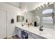 Bright bathroom with double sinks, a large mirror, modern fixtures, and a soaking tub at 3793 S Seton Ave, Gilbert, AZ 85297