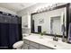 Stylish bathroom featuring a gray vanity, a large mirror, and a shower with a dark blue curtain at 3793 S Seton Ave, Gilbert, AZ 85297