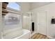 Bright bathroom featuring a soaking tub, glass-enclosed shower, and modern fixtures at 3793 S Seton Ave, Gilbert, AZ 85297