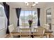 Bright dining room featuring a wood table, chandelier, and a view of the outdoor pool at 3793 S Seton Ave, Gilbert, AZ 85297