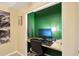 Bright home office space featuring wood desk, green accent wall, and a comfortable workspace at 3793 S Seton Ave, Gilbert, AZ 85297