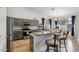 Open kitchen featuring gray cabinets, granite countertops, and bar seating with views of the dining room at 3793 S Seton Ave, Gilbert, AZ 85297