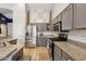 Kitchen featuring stainless steel appliances, gray cabinets, granite countertops, and tile flooring at 3793 S Seton Ave, Gilbert, AZ 85297