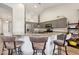 Well-lit kitchen featuring gray cabinets, granite countertops, stainless steel appliances, and bar seating at 3793 S Seton Ave, Gilbert, AZ 85297