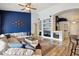 Open concept living room with blue accent wall, sofa, and wood-look tile floors at 3793 S Seton Ave, Gilbert, AZ 85297