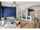 Open concept living room with blue accent wall, sofa, and wood-look tile floors at 3793 S Seton Ave, Gilbert, AZ 85297