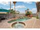 Beautiful backyard features a refreshing pool, hot tub, waterfall, and well-maintained landscaping and patio at 3793 S Seton Ave, Gilbert, AZ 85297