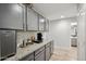 Elegant wet bar with gray cabinetry, granite countertop, wine fridge and a coffee maker at 3793 S Seton Ave, Gilbert, AZ 85297