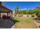 Spacious backyard featuring a hot tub, covered patio, and mature landscaping at 3907 N 143Rd Ln, Goodyear, AZ 85395