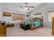 Cozy bedroom showcasing a wooden bed frame, natural light, and decor at 3907 N 143Rd Ln, Goodyear, AZ 85395