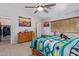 Bedroom with a cozy wooden bed and a classic wooden dresser at 3907 N 143Rd Ln, Goodyear, AZ 85395