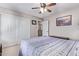 Bright bedroom featuring a ceiling fan, large closet, and comfortable bed, perfect for relaxation at 3907 N 143Rd Ln, Goodyear, AZ 85395