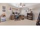 Neutral bedroom with a ceiling fan, a desk, and a bookshelf at 3907 N 143Rd Ln, Goodyear, AZ 85395