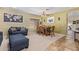 Comfortable dining room with wooden furniture, carpet and tiled floors, and a blue sofa at 3907 N 143Rd Ln, Goodyear, AZ 85395