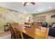 Open-concept living and dining room with a wooden table and staircase at 3907 N 143Rd Ln, Goodyear, AZ 85395