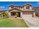 Charming two-story home featuring a well-manicured lawn, a two car garage and desert landscaping at 3907 N 143Rd Ln, Goodyear, AZ 85395