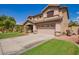 Attractive two-story home featuring desert landscaping, a spacious driveway, and a two-car garage at 3907 N 143Rd Ln, Goodyear, AZ 85395