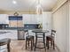 Bright eat-in kitchen featuring white cabinets, stainless steel appliances, and granite counters at 3907 N 143Rd Ln, Goodyear, AZ 85395