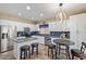 Eat-in kitchen featuring white cabinets, stainless steel appliances, granite countertops, and an island at 3907 N 143Rd Ln, Goodyear, AZ 85395