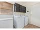 Functional laundry room with a washer, dryer, and storage cabinets at 3907 N 143Rd Ln, Goodyear, AZ 85395