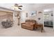 Comfortable living area with a ceiling fan, side tables, and couch, creating a cozy retreat at 3907 N 143Rd Ln, Goodyear, AZ 85395