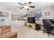 Cozy living room featuring a ceiling fan, neutral walls, and comfortable seating area at 3907 N 143Rd Ln, Goodyear, AZ 85395