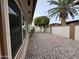 Spacious backyard with decorative rock and mature trees, perfect for relaxing at 4026 E Catalina Cir, Mesa, AZ 85206