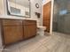 Bathroom featuring tile flooring, wooden vanity, toilet, and tile shower with glass door at 4026 E Catalina Cir, Mesa, AZ 85206