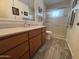 Bathroom featuring tile flooring, wooden vanity, toilet, and shower with sliding door at 4026 E Catalina Cir, Mesa, AZ 85206