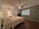 Bedroom with hardwood floors, ceiling fan, and windows with shutters at 4026 E Catalina Cir, Mesa, AZ 85206