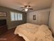 Bedroom with ceiling fan, hardwood floors, and shutters at 4026 E Catalina Cir, Mesa, AZ 85206