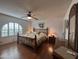 Comfortable main bedroom with wood floors, ceiling fan, large window, and classic decor at 4026 E Catalina Cir, Mesa, AZ 85206