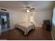 Bedroom with wood floors, ceiling fan, and TV at 4026 E Catalina Cir, Mesa, AZ 85206