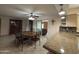 A dining space with a vintage grandfather clock near the open kitchen and adjoining living space at 4026 E Catalina Cir, Mesa, AZ 85206