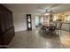 Open-concept dining area with tile flooring, vintage grandfather clock, and adjacent kitchen access at 4026 E Catalina Cir, Mesa, AZ 85206