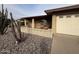 Inviting single-story home featuring easy desert rock landscaping, with front porch at 4026 E Catalina Cir, Mesa, AZ 85206