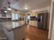 Bright kitchen featuring wood flooring, granite countertops, stainless steel appliances, and white cabinetry at 4026 E Catalina Cir, Mesa, AZ 85206