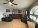 Cozy living room with tile floors, fan and two comfortable leather reclining chairs at 4026 E Catalina Cir, Mesa, AZ 85206