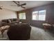 Living room with sofa, ceiling fan, and two windows at 4026 E Catalina Cir, Mesa, AZ 85206