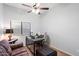 Bedroom with ceiling fan, window, workstation, sofa and ottoman at 4317 E Williams Dr, Phoenix, AZ 85050