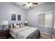 Bedroom featuring carpeted floor, neutral-colored walls, a ceiling fan and bright window at 4317 E Williams Dr, Phoenix, AZ 85050