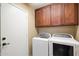 Laundry room with washer, dryer, and overhead cabinets at 4317 E Williams Dr, Phoenix, AZ 85050